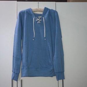 Blue sweater with crisscross rope